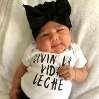 Happy Breastfed Baby wearing a shirt that says "living la vide leche"
